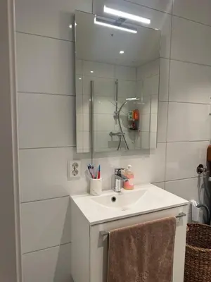 a bathroom with a sink and a mirror at Oceanfront Stay, Large Balcony and Rooftop Access in Bergen