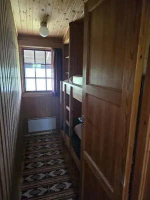 a small hallway with a door and a window at Utsikten in Geilo