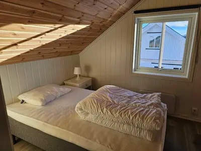 a bedroom with a bed in a room with a window at Flott hytte i Elgtrakket 9, 3864 Rauland Skisenter - Holtardalen in Torvetjørn