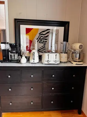 a black dresser with appliances on top of it at Kikays Hygge in Bysheim