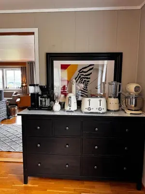 a black dresser with appliances on top of it at Kikays Hygge in Bysheim