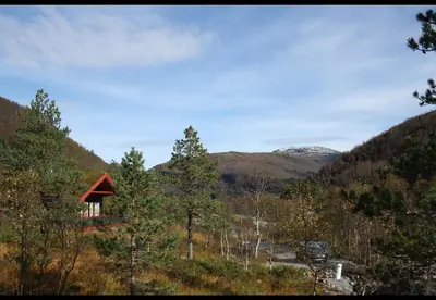 a small cabin in the middle of a mountain at Spacious Wood Cabin 50 min from Bergen in Eikedalen