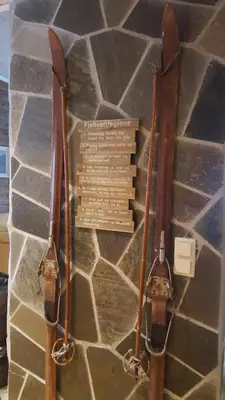 two old skis on display on a stone wall at Spacious Wood Cabin 50 min from Bergen in Eikedalen