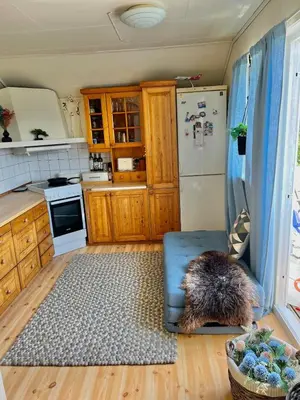 a kitchen with a dog sitting on a couch in a kitchen at Studio in Os Near Bergen