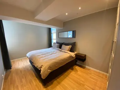 a bedroom with a bed and a window in it at Spacious Modern Apartment City center in Bergen