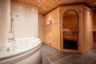 a bathroom with a tub and a sink and a kitchen at Trysilfjellet Sør 802 in Trysil