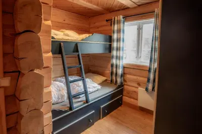 a room with bunk beds in a log cabin at Trysilfjellet Sør 802 in Trysil