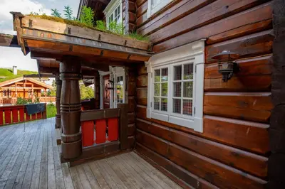 a wooden house with a door and windows on it at Trysilfjellet Sør 802 in Trysil