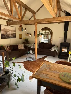 a living room with a couch and a table at Gjestehus i Hurdal uten innlagt vann Delt bad in Hurdal