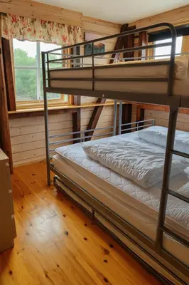 two bunk beds in a room with a window at Family-friendly Cabin with pier - Herdla to Bergen - 40 min in Herlø
