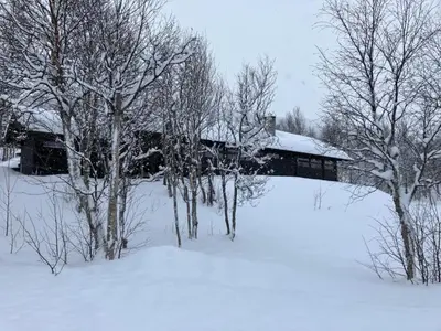 a bridge covered in snow with trees and a building at Ski in ski out in Geilo, comfortable and family friendly cabin in Geilo