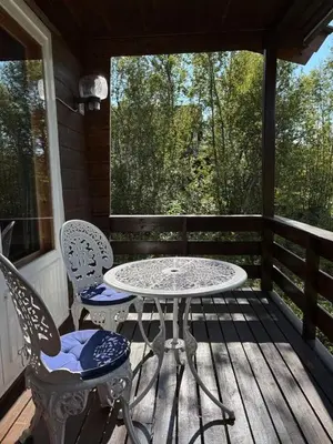 a patio with a table and chairs on a porch at Geilo - Hyggelig og sentral hytte in Hol