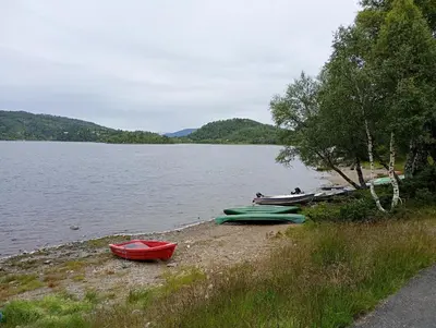 three boats sitting on the shore of a lake at Gullingen Cabin Winter Wonderland