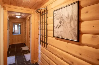 a hallway in a log cabin with a painting on the wall at Trysilfjellet Sør 480 in Trysil