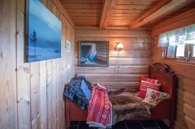 a small room with a bed in a wooden cabin at Trysilfjellet Sør 480 in Trysil