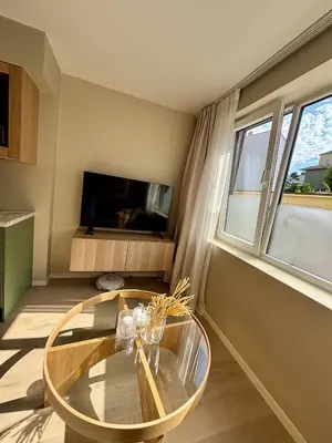 a living room with a glass table and a tv at Leilighet i Bergen sentrum in Bergen
