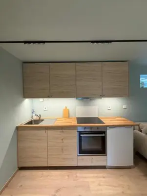 a kitchen with wooden cabinets and a sink at Moderne leilighet in Bergen