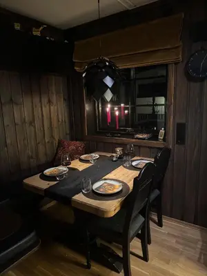 a dining room table with plates and glasses on it at Norefjell Ski in - Ski out in Noresund