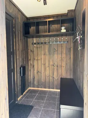 a room with a wooden wall with a bench in it at Norefjell Ski in - Ski out in Noresund