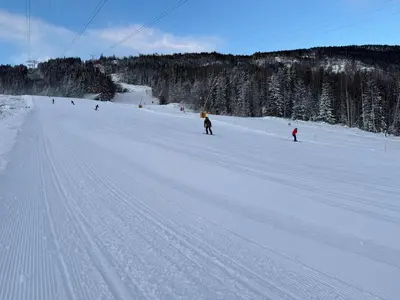 a group of people skiing down a snow covered slope at Norefjell Ski in - Ski out in Noresund