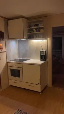 a kitchen with a stove and a counter top at Et hus dypt i havet in Steinshamn