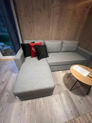 a gray couch in a room with a table at Solsiden Geilo Cozy Studio location Geilo Centrum in Hol