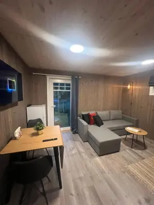 a living room with a couch and a table at Solsiden Geilo Cozy Studio location Geilo Centrum in Hol