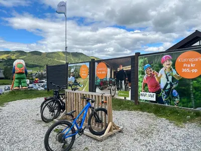 a blue bike is parked next to a sign at Solsiden Geilo Cozy Studio location Geilo Centrum in Hol