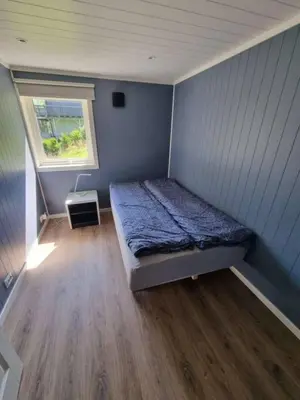 a small bedroom with a bed and a window at The simple appartment in Stryn in Stryn