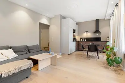 a living room with a gray couch and a table at Inviting & Cozy City Apartment in Bergen