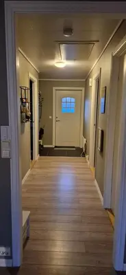 a hallway of a home with a door at Central Langevåg Family Apartment in Sula