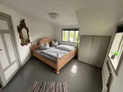 a bedroom with a bed and a window at Haus Harald in Tysnes
