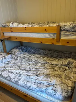 a wooden bunk bed in a room at Apartment vårstølen in Vossevangen