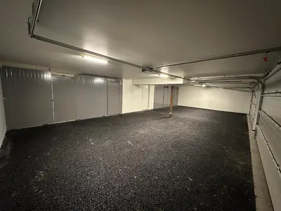 an empty parking lot with stalls in a garage at Motoppen Trysil Apartments in Trysil