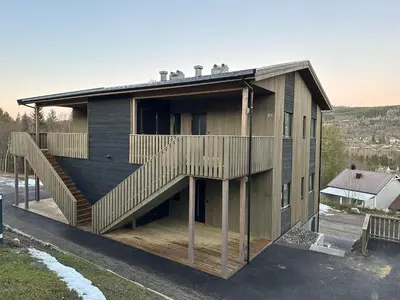 a house with a staircase on the side of it at Motoppen Trysil Apartments in Trysil