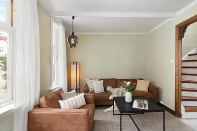 a living room with a couch and a table at Historic Gem I Charming Bergen Home in Bergen
