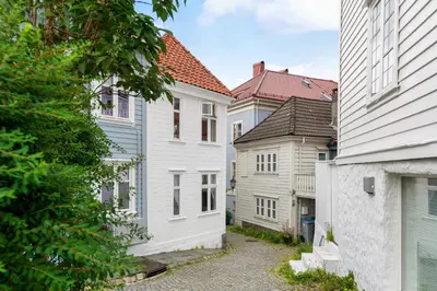 a row of white houses in a street at Historic Gem I Charming Bergen Home in Bergen