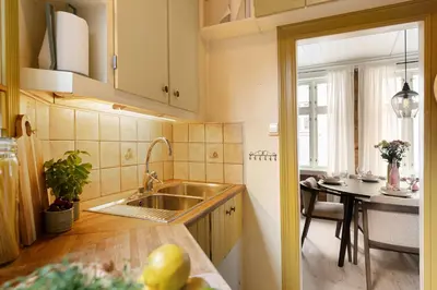 a kitchen with a sink and a table at Historic Gem I Charming Bergen Home in Bergen