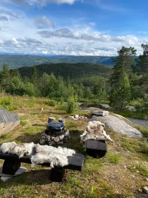 a fire pit on top of a hill with a view at Blefjell hytte med fantastisk utsikt in Kongsberg