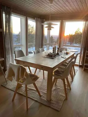 a dining room with a wooden table and chairs at Blefjell hytte med fantastisk utsikt in Kongsberg