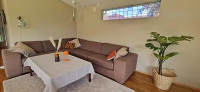 a living room with a couch and a table at Hus ved sjøen, med strand og naust in Sauda