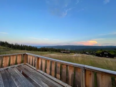 a wooden deck with a view of the mountains at Annebu by Norgesbooking - cabin at 1000 meter with amazing view in Ål