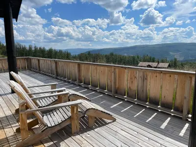 a deck with two chairs and a view of the mountains at Annebu by Norgesbooking - cabin at 1000 meter with amazing view in Ål