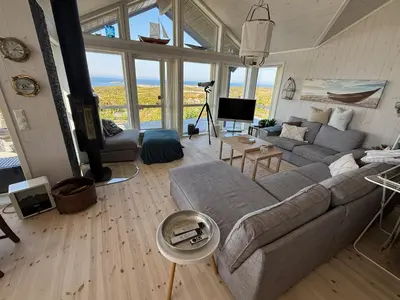 a living room with a couch and a tv at Drømmeplassen in Averoy