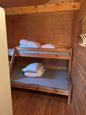 a room with three bunk beds in a cabin at Sjøbakken Fjord Camping AS in Sykkylven