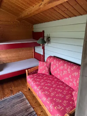 a couch sitting inside of a room with a ceiling at Sjøbakken Fjord Camping AS in Sykkylven