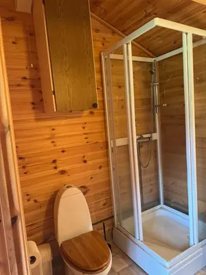 a bathroom with a shower and a toilet at Sjøbakken Fjord Camping AS in Sykkylven
