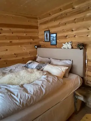 a bedroom with a bed in a log cabin at Hytte med panoramautsikt i Uvdal in Nørdstebø