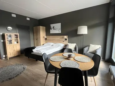 a bedroom with a bed and a table and chairs at Trysil Alpine Lodge - 510 in Trysil