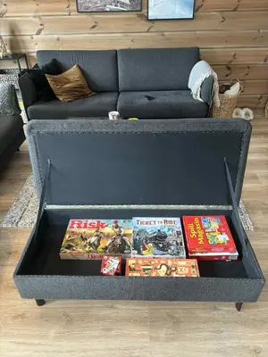 a table with two video games on it in front of a couch at Fjellhytte sentralt og solrikt in Stryn